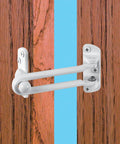 Built Like A Tank Swing Bar Door Lock For Hinged Entryways Secondary Security Latch With Kid Safe Ventilation Setup Solid Zinc Build White Finish mounted on wood door.