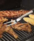 Grilling chicken with stainless steel fork from 36 Piece Grill Tool Set With Spatula Fork Tongs Basting Brush Replacement Brush Heads Heat Resistant Gl...