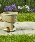 Hand Powered Lawn Spreader For Grass Seed Fertilizer Salt Ice Melt With Adjustable Arm Support on stone path