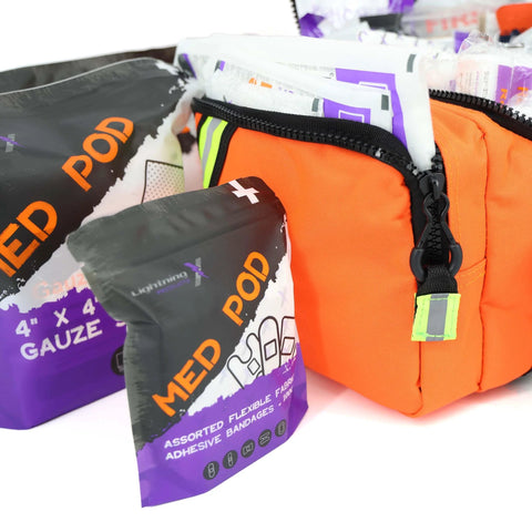 Orange Lightning X EMS trauma bag with black zipper; stocked with gauze packs.