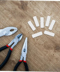 100 Pcs Nylon Hidden Fasteners And Double Headed Furniture Connectors To Keep Shelves And Cabinets Locked Down Tight With A Smooth Clean Look Heavy Duty Workshop Gear For Reliable Diy Build displayed with pliers on a wood surface.
