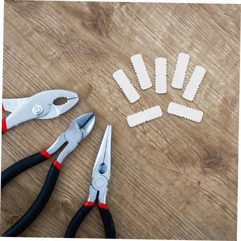 100 Pcs Nylon Hidden Fasteners And Double Headed Furniture Connectors To Keep Shelves And Cabinets Locked Down Tight With A Smooth Clean Look Heavy Duty Workshop Gear For Reliable Diy Build displayed with pliers on a wood surface.
