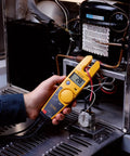 Non Contact Voltage And Current Tester With Auto AC DC Detection in use, measuring AC voltage, OpenJaw reading, held by electrician