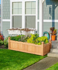 Wooden Raised Garden Bed Planter Box For Yard And Greenhouse Outdoor Use, Rectangular Planter For Vegetables, Flowers, Herbs, Durable Wood, Low Maintenance, 43.5 Inch L By 16 Inch W By 14 Inch H, Light Brown outside a house.