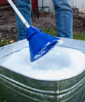 Portable Manual Clothes Washer Plunger Working As A Smooth Washing Agitator for bucket with soapy water in galvanized tub.