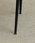 Close-up of a chair leg with Grippy Rubber Washer Foot Pads With Screw Holes 10 Pack Non Slip Vibration Dampening Mats For Washing Machines