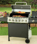 Outdoor grill with open lid, cooking food, connected to two foot propane gas grill regulator and hose for Weber Charbroil Nexgrill grills patio heaters and fire pits replacement low pressure LP regulator for grills heaters lanterns camp stoves.