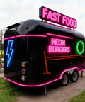 Commercial Grade Coffee Trailer And Mobile Hot Dog Cart Featuring Chef Ready Full Kitchen Setup With Plug And Play Wiring To Help You Crush Sales At Street Events, black exterior with neon signage.