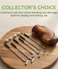 Alloy Mini Golf Club Set With Six Clubs And Four Balls for Dollhouse Dioramas, silver clubs and balls with leather bag on wood surface.