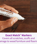 Hand using Exact Match Wood Furniture And Floor Repair Markers, 6 Count Brown Markers for scratches on wooden surface.
