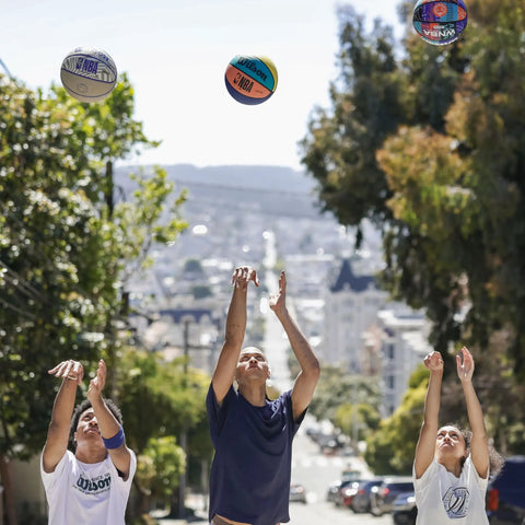 Players shooting basketballs in a street with NBA DRV Series Basketball Official Size 7 29.5 Inch Brown and other models visible