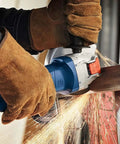 Built Different Five Inch Angle Grinder crunches concrete and metal up to 11500 RPM while cutting steel with sparks flying.