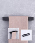 Matte Black SUS304 Stainless Steel Towel Holder Wall Mount Towel Ring And Hanger For Bathroom Lavatory Modern Square Design Rustproof Finish Heavy Duty And Easy Cleaning HG1706-BK with towel displayed against gray background.