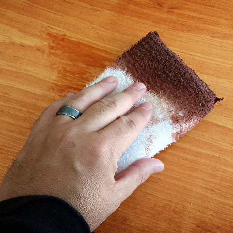 Hand using Twin Pack 4x5 White Terry Cloth Staining Pad With SuperTuff Sponge for smooth stain application on wood surface