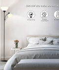 LED Torchiere Floor Lamp With Adjustable Reading Light For Bedroom And Living Room, Matte Black Standing Lamp beside a bed