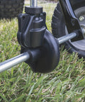 Close-up of Tow Behind Broadcast Spreader With 85 Lb Capacity For Lawns assembly part near 10 inch pneumatic tire on grass