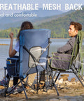 Oversized Folding High Back Lawn Chair for Adults With Cup Holder, Carrying Strap, Hard Armrests, 400Lb Capacity, Blue, Ideal for Camping, Fishing, Hunting, Sports, and Backyard shown by a lake