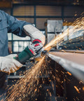 Worker using 5 Inch Brushless Angle Grinder 2000 Watt Pro Grade for industrial metal grinding, sparks flying