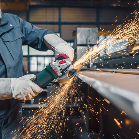 Worker using 5 Inch Brushless Angle Grinder 2000 Watt Pro Grade for industrial metal grinding, sparks flying