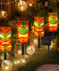 4 Pack Solar Tiki Light Decor Waterproof Tiki Statues For Outdoor Hawaiian Party in garden with glowing lights