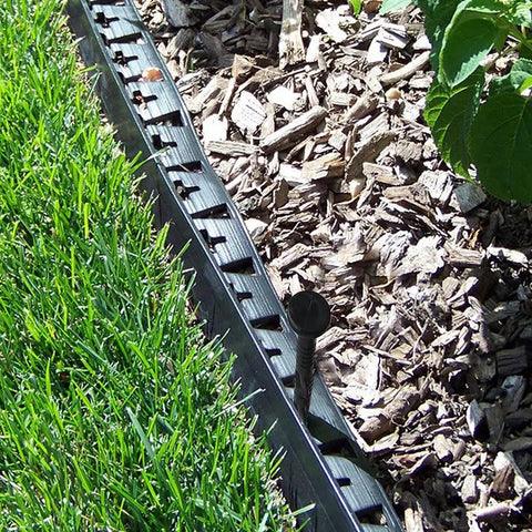 Spiral Landscape Anchoring Spikes 8 Inch Set For Lawn Edging installed along lawn and mulch border.