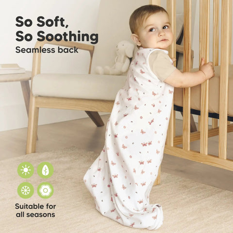 Baby in Two Pack Organic Cotton Baby Sleep Sacks 0.5 TOG for 6 to 18 Months Butterflies Pattern, standing by crib