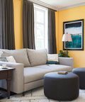 Living room with Rustic Oil Rubbed Bronze Floor Lamp With Leaf Finial And Gold Tapered Shade, cozy grey sofa, and dark ottomans.