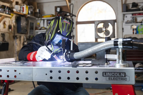 Person using Weld Pak 225i Dual Voltage Stick and TIG Welder 120V 230V, 10 to 225 Amp Output in home garage setting