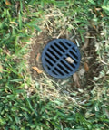 4 Inch Plastic Round Drainage Grate Cover No Fuss Debris Guard installed in lawn keeping junk out
