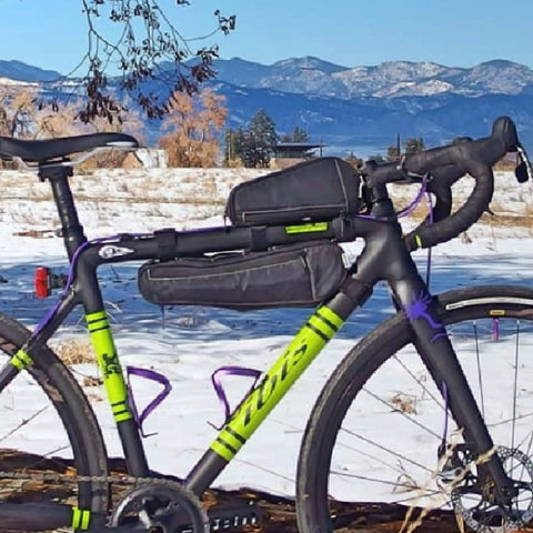 Bicycle with Long John Frame Bag For Bikes With Dual Duty Top Tube And Frame Storage, Side Zippers, Multi-Position Straps in snowy landscape