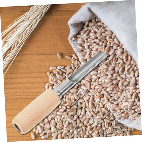 Stainless Steel Grain Sampler With Wooden Handle For Wheat And Rice Sampling, showing tool on grains