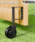 Heavy Duty 4.3 Inch Gate Wheels Black Outdoor Fence Casters With 360 Degree Swivel Spring Loaded Design mounted on a wooden gate