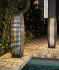 Outdoor Solar Powered Floor Lamp With Weatherproof Wicker Lantern in garden setting by pool, two lamps, silver gray.