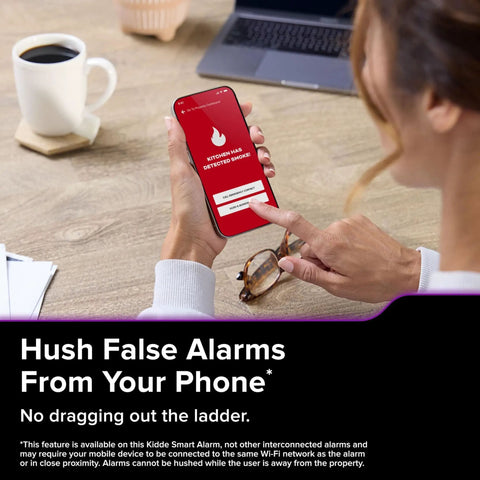 Person holding smartphone showing app notification for App Enabled Hardwired Smart Smoke And Carbon Monoxide Detector With AA Battery Backup