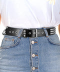 Person wearing Rock Rivet Belt With Pyramid Studs, Edgy Punk Studded Belt For Women And Men, Black Metal Grommet Belt