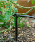 Tomato Garden Drip Irrigation System Kit For 10 Plants With Push Connect Fittings watering green plant in soil