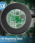 Four Arm Soldering Gear With 5X Magnifier And Light, showing magnified view of a circuit board, used for precise welding and assembly.