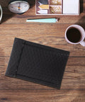 Black Padded Bubble Mailer Envelopes 12x18 on wooden desk with coffee cup and stationery