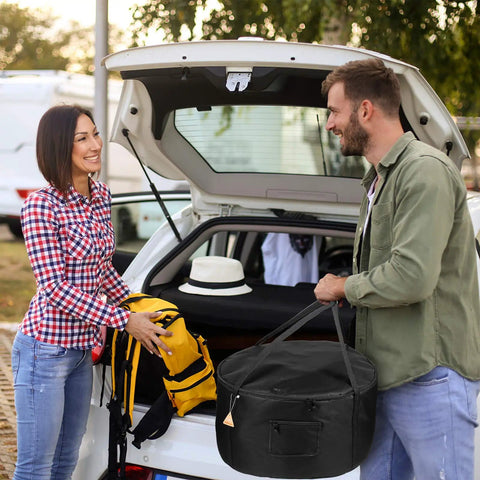 Couple with a car trunk loading a Beefy Heavy Duty Water Resistant Carrying Bag For 19 Inch Outdoor Propane Fire Pit