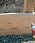 Using a power drill on wood with Hardcore Exterior Grade Timber Screws Four Inch Heavy Duty Wood Fasteners With Double Barrier Coating And Wide Washer Head Built Like A Tank For Rough Job Sites And Drives Dead Nuts Tight Pack Of Fifty.