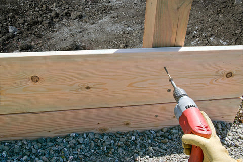 Using a power drill on wood with Hardcore Exterior Grade Timber Screws Four Inch Heavy Duty Wood Fasteners With Double Barrier Coating And Wide Washer Head Built Like A Tank For Rough Job Sites And Drives Dead Nuts Tight Pack Of Fifty.