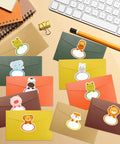 135 Jungle Animal Name Tag Stickers For Kids And Students on colorful envelopes, featuring various animal designs like lion and elephant.