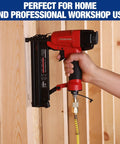 Person using a pneumatic nail gun with Pro Grade 16 Piece One Quarter Inch NPT Air Hose Fitting Kit With Storage Case Includes Quick Connect Brass Couplers And Plugs For Air Compressors And Pneumatic Tools, attached to a wooden panel.