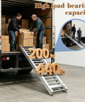Two men using a Stainless Steel Roller Conveyor Slide Foldable Portable Heavy Duty Industrial Gravity Transport Cart for unpacking.