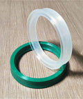 Premium Polyurethane Hydraulic Cylinder Oil Sealing Ring Set For Piston Rod Shafts With Y And U Shape Configurations Designed To Stop Leaks And Ensure Peak Performance For Heavy Machinery Operators Needing Rock Solid Reliability Today. White and green polyurethane sealing rings on wood surface