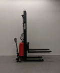 Heavy Duty Thin Leg Semi Electric Pallet Stacker side view with 138 inch lift height and 2204 lbs capacity on warehouse floor.