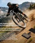 Mountain biker riding downhill with disc brake pads, showcasing Front And Rear Disc Brake Caliper Kit With Resin Semi Metallic Pads For F160 R140 F180 R160 Systems Compatible With Shimano MT200 Tektro And Most Mountain And Electric Bikes And Scooters Beefed Up Braking Performance.
