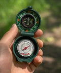 Trail Ready Compact Hiking Compass With Thermometer for Camping and Outdoor Navigation held in hand on trail