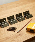 270 Degree Three Fold Half Surface Hinges Set with screws, pencil, and tape measure on wooden surface, bronze finish