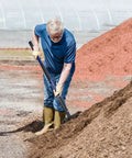 Man using Five-Tine Pitchfork For Gardening 57-Inch Heavy Duty Garden Fork With Fiberglass Handle For Mulch Compost Manure Hay And Soil Loosening Blue Built For Tough Jobs.